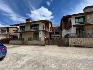 an empty parking lot in front of a house at Cottage Crystal Bakuriani in Bakuriani