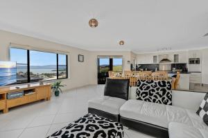 a living room with a couch and a kitchen at Spacious Home With Lake Views in Lake Heights