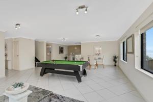 a living room with a pool table in it at Spacious Home With Lake Views in Lake Heights