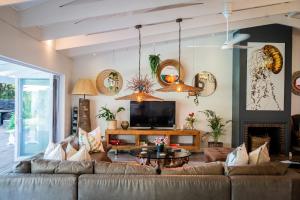 a living room with a couch and a tv at Luxury Private Beach Villa centrally located. in Westbrook