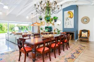 a dining room and living room with a table and chairs at Luxury Private Beach Villa centrally located. in Westbrook