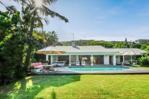 a house with a swimming pool in a yard at Luxury Private Beach Villa centrally located. in Westbrook