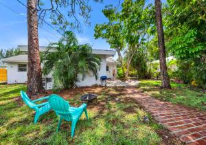 a yard with two chairs and a table and trees at Stunning 1 BD 1BA In Naples in Naples