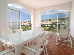 a white dining room with a table and chairs at Alta Vista Alcaidesa 2251 in La Alcaidesa