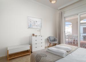 a bedroom with a bed and a desk and a window at Alta Vista Alcaidesa 2251 in La Alcaidesa