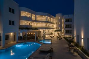 a swimming pool in front of a building at night at Anastasia Hotel in Kos
