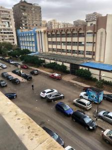 a parking lot full of cars in a city at Luxury family apartment in Cairo