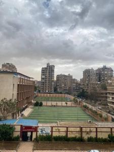 a tennis court in the middle of a city at Luxury family apartment in Cairo