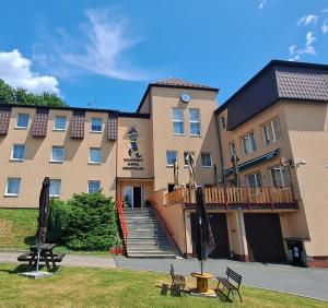 a large building with a staircase in front of it at Hasičský hotel Přibyslav in Přibyslav