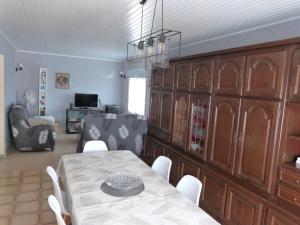 a dining room with a table and a living room at Gîte tout confort au bord de la Meuse avec jardin et activités familiales à proximité - FR-1-585-82 in Vilosnes-sur-Meuse