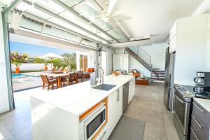 an open kitchen with a view of a dining room at Oceanside 2 Bedroom Luxury Villa with Private Pool, 500ft from Long Bay Beach -V3 in Providenciales