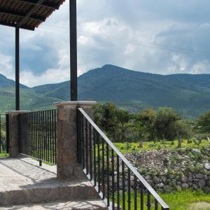 a balcony of a house with a view of mountains at Naakary Home in San Miguel de Allende
