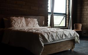 a bed sitting in a room with a window at Naakary Home in San Miguel de Allende