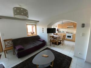 a living room with a couch and a table at Gîte La Bresse, 2 pièces, 4 personnes - FR-1-589-407 in La Bresse