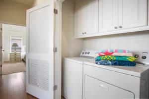 a white laundry room with a washer and dryer at Beach Front Cottage with Beautiful Ocean Views! in Bolivar Peninsula +15 photos