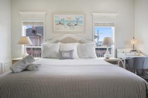 a white bedroom with a large bed with white pillows at Beach Front Cottage with Beautiful Ocean Views! in Bolivar Peninsula
