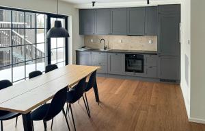 a kitchen with a wooden table and some chairs at Nice Apartment In Idre With House A Panoramic View in Idre