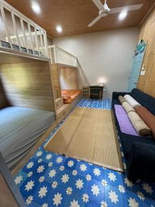 a room with two bunk beds and a ladder at cinderella home stay in Vĩnh Long
