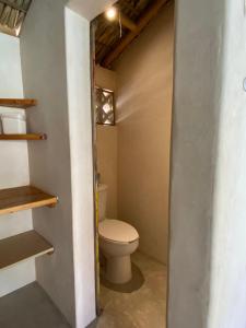 a bathroom with a toilet in a room at Casa Terra in Paso Hondo