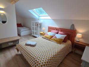 Schlafzimmer mit einem Bett und einem Dachfenster in der Unterkunft Gîte Artenay, 5 pièces, 10 personnes - FR-1-590-255 in Artenay