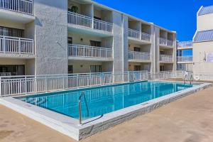 a swimming pool in front of a apartment building at Sugar Beach in Gulf Shores