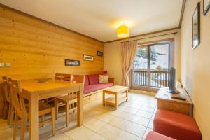 a living room with a table and a couch at Appartement B56 - Eco Le Ruitor in Sainte-Foy-Tarentaise