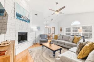 a living room with a couch and a fireplace at 4BR house, 2 blocks from the beach in St. Augustine