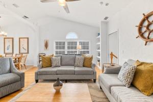 a living room with two couches and a table at 4BR house, 2 blocks from the beach in St. Augustine +57 photos