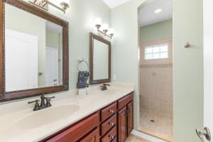 a bathroom with two sinks and a shower at 4BR house, 2 blocks from the beach in Saint Augustine