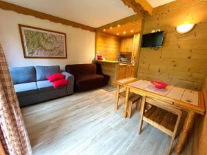 a living room with a couch and a table at Superb studio Terrace Ski in Montchavin in La Plagne Tarentaise +10 photos