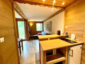 a kitchen and living room of a log cabin at Superb studio Terrace Ski in Montchavin in La Plagne Tarentaise