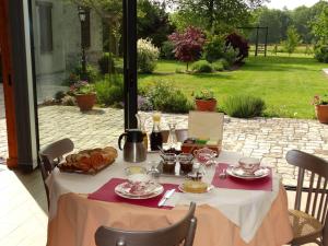 a table with a white table cloth with food on it at Chambre familiale au cœur de la nature avec jardin et piscine privée, idéale pour explorer le Loiret - FR-1-590-265 in Vitry-aux-Loges
