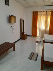 a living room with a couch and a table at Sisila Guest House in Anuradhapura