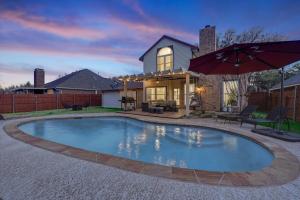 a swimming pool in front of a house at Amazing 4 Bedroom Home with Cinema Room Poker &Private Pool Great Location in Mesquite