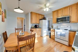 a kitchen with a wooden table and a dining room at Charming Emporia Home with Deck and Patio! in Emporia