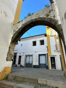 an archway in front of a white building at Bombarda 15 Evora in Évora