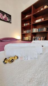 a white bed with a sign on top of it at Da Fabio e Francesca - Holiday Apartment in Verona