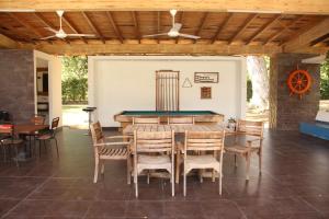 a dining room with a pool table and chairs at Hermosa Finca La Rochela, Santa fe de Antioquia in Santa Fe de Antioquia