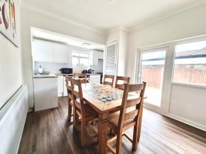 a kitchen and dining room with a table and chairs at Beautiful quiet Victorian Bungalow heart of London in London