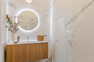 a bathroom with a sink and a mirror at Casa Lazzaro Contemporary Ground Floor Apartment in Lucca