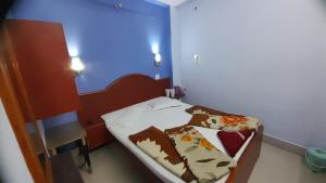 a small room with a bed in a room at Hotel swapanlok, Couple Friendly Hotel in Muzaffarpur