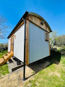 a smallshed sitting on top of a field at The Hut@Trefechan Wen - Coastal Coziness! in Goodwick