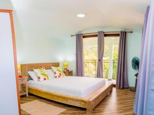 a bedroom with a bed and a window at Spacious apartment with sea view, Au Cap, 124 m² in Au Cap