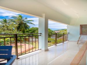 a balcony with a view of the ocean at One bedroom appartement at Au cap 100 m away from the beach with enclosed garden and wifi in Au Cap