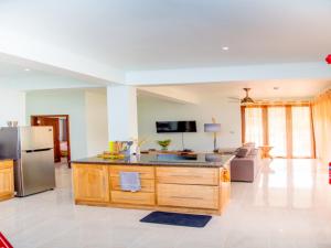 a kitchen with an island in the middle of a room at One bedroom appartement at Au cap 100 m away from the beach with enclosed garden and wifi in Au Cap