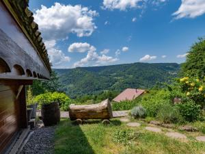 a room with a view of the mountains from a house at Chalet ensoleillé dans les Hautes Vosges avec terrasse, local vélos et skis, charges incluses - FR-1-589-486 in Thiéfosse