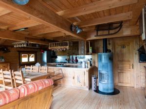a large kitchen with wooden floors and a wooden ceiling at Chalet ensoleillé dans les Hautes Vosges avec terrasse, local vélos et skis, charges incluses - FR-1-589-486 in Thiéfosse