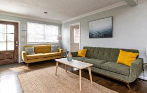 a living room with a couch and a table at The Hammock House in Virginia Beach