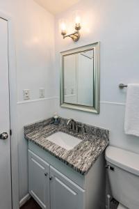 a bathroom with a sink and a mirror at The Hammock House in Virginia Beach