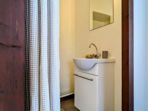a bathroom with a sink and a shower curtain at Évasion au cœur de Polignac : Charme et confort à deux pas du Puy-en-Velay - FR-1-582-382 in Polignac